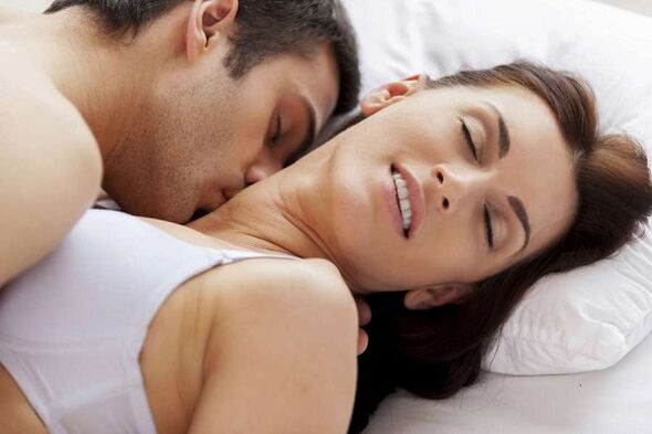 An excited man and a woman in bed
